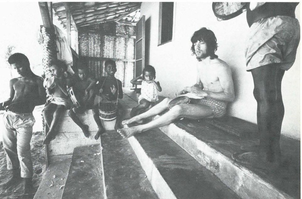 Photographs of Adger W. Cowans — Mick Jagger stoned playing a drum with kids in Brazil.