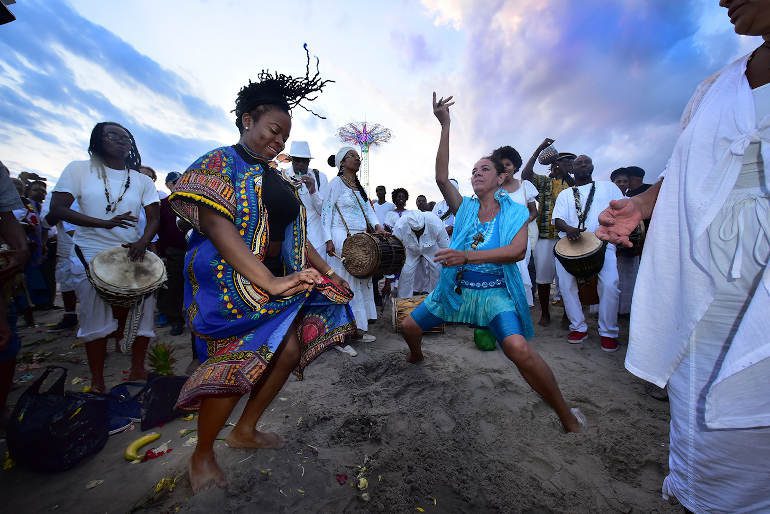 Drumming and dancing takes place to enjoy the customs of the ancestors. The drum is a sacred instrument and used in most rituals. It is like the beat of the heart – it is in the DNA and dancing is a wonderful thing that happens naturally . The enslaved were not allowed to play a drum because slave owners knew that drums were used to communicate and send messages. Coney Island, NYC - (Tribute to the ancestors organized by Akeem for The People of the Sun Tribute to the Ancestors of the Middle Passage Collective.