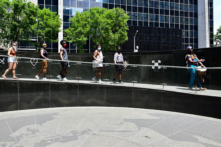 burial.. people walking backwards from the monument- the purpose for this is to not turn your backs to the enslaved.
