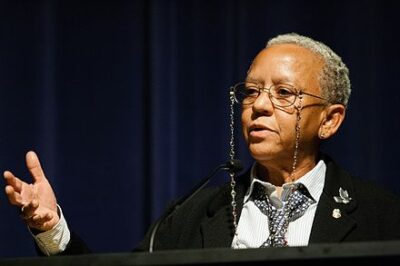 iYolande "Nikki" Giovanni speaking at Emory University in 2008. glasses, tie and black jacket