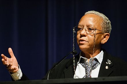 iYolande "Nikki" Giovanni speaking at Emory University in 2008. glasses, tie and black jacket