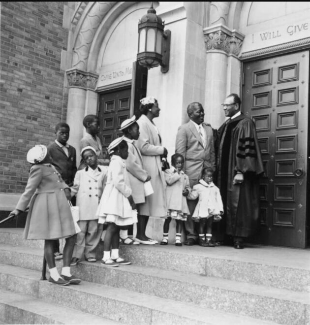 A couple and their eight children stand with Pastor Reverend Gardner C. Taylor on the steps of Concord Baptist Church after Easter services in Brooklyn, April 22, 1962.