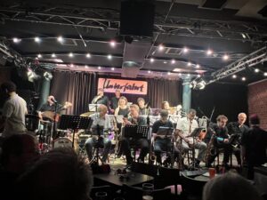 Sebastian “Schoko” Koelbl—a 30-year-old trumpeter, composer, arranger, and conductor of both German and African heritage. For his final performance before receiving his Master’s degree, Schoko didn’t just conduct—he presented himself as a soloist, playing trumpet on every piece he wrote and arranged himself. 